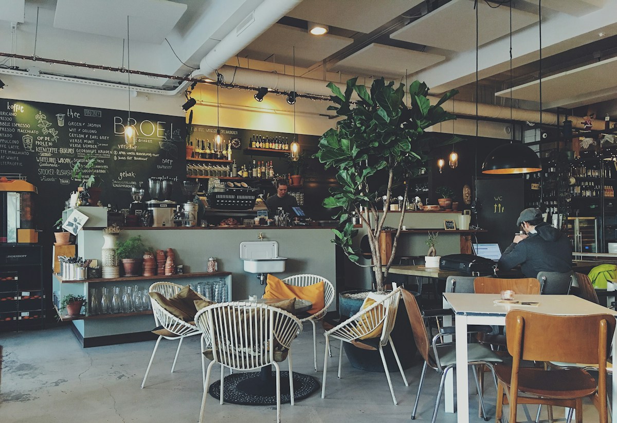 A welcoming café interior with wooden tables and a coffee counter